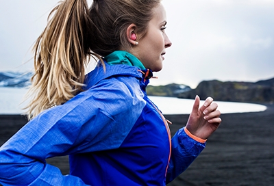 A woman jogging with earbuds in A woman jogging with earbuds in
