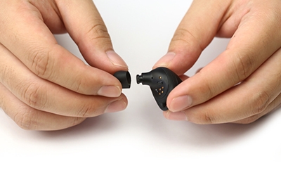 Hands attaching earbud tips to Galaxy Buds Hands attaching earbud tips to Galaxy Buds
