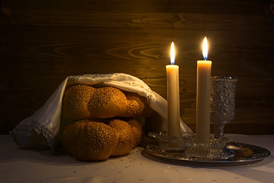 Challah bread and candles on a table
