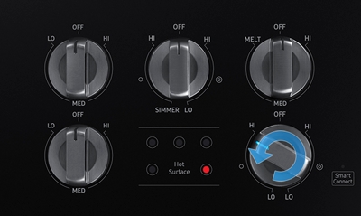 The control knobs with a turn counterclockwise icon imposed on the bottom right knob, and the hot surface indicator light is lit
