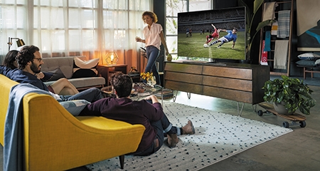 Group of people watching TV together in a living room