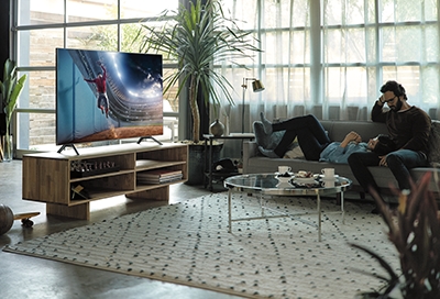 Man and women in the living room watching TV