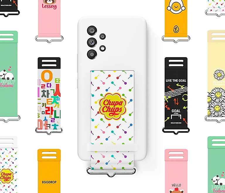 Strap to your tastes At the center, a Galaxy A53 wearing a white Silicone Cover with a colorful, customized Chupa Chups collaboration strap. Surrounding the device are various other colorful straps that have collaborated with various brands.
