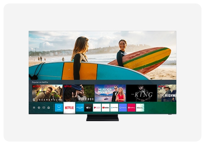 A scene of two women carrying their surfboards and looking each other as they're standing at the beach. The screen shows multiple different Netflix show ads in the bottom panel