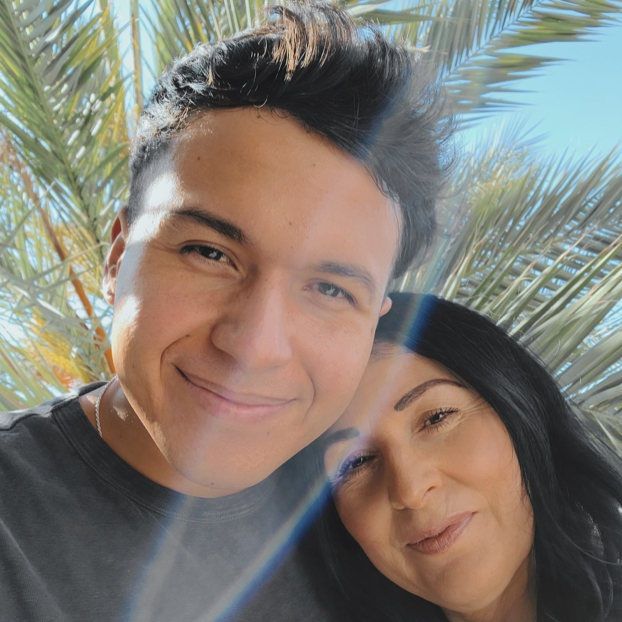 Selfie of a guy with his mom in front of palm trees Selfie of a guy with his mom in front of palm trees