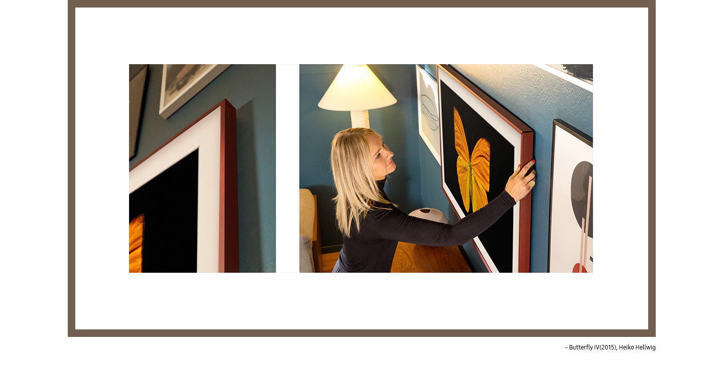 Kirsten Grove installs burgundy bezels onto The Frame hanging flush to the wall and displaying Butterfly IV(2015) by Heiko Hellwig.