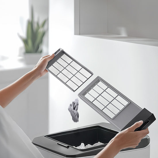 Person effortlessly cleaning the vented all-in-one washer dryer lint filter Person effortlessly cleaning the vented all-in-one washer dryer lint filter