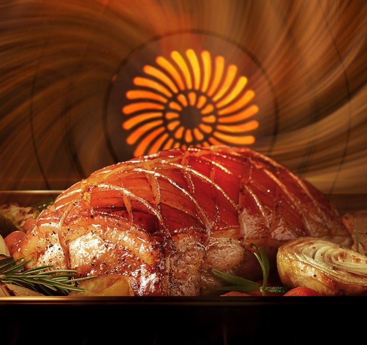 Faster, more even baking* than Convection Close-up of a Roast Among Vegetables & Herbs Inside a Convection Oven