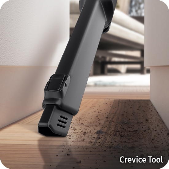 Crevice tool picking up dirt in difficult-to-access area behind sofa Crevice tool picking up dirt in difficult-to-access area behind sofa