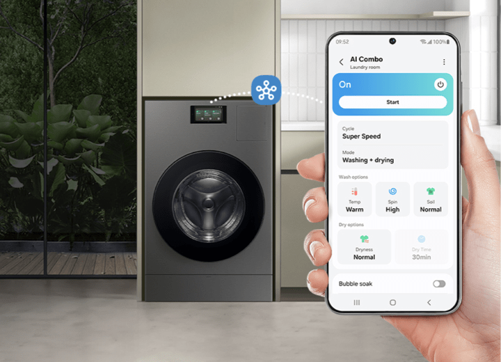 Remotely schedule cycles Person holding smartphone connected to washer dryer combo via SmartThings app