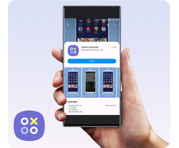 Game Launcher System A hand holds a Samsung Galaxy Note10 up vertically, displaying the Game Launcher app onscreen. The Game Launcher app icon sits in the bottom left corner of the image.
