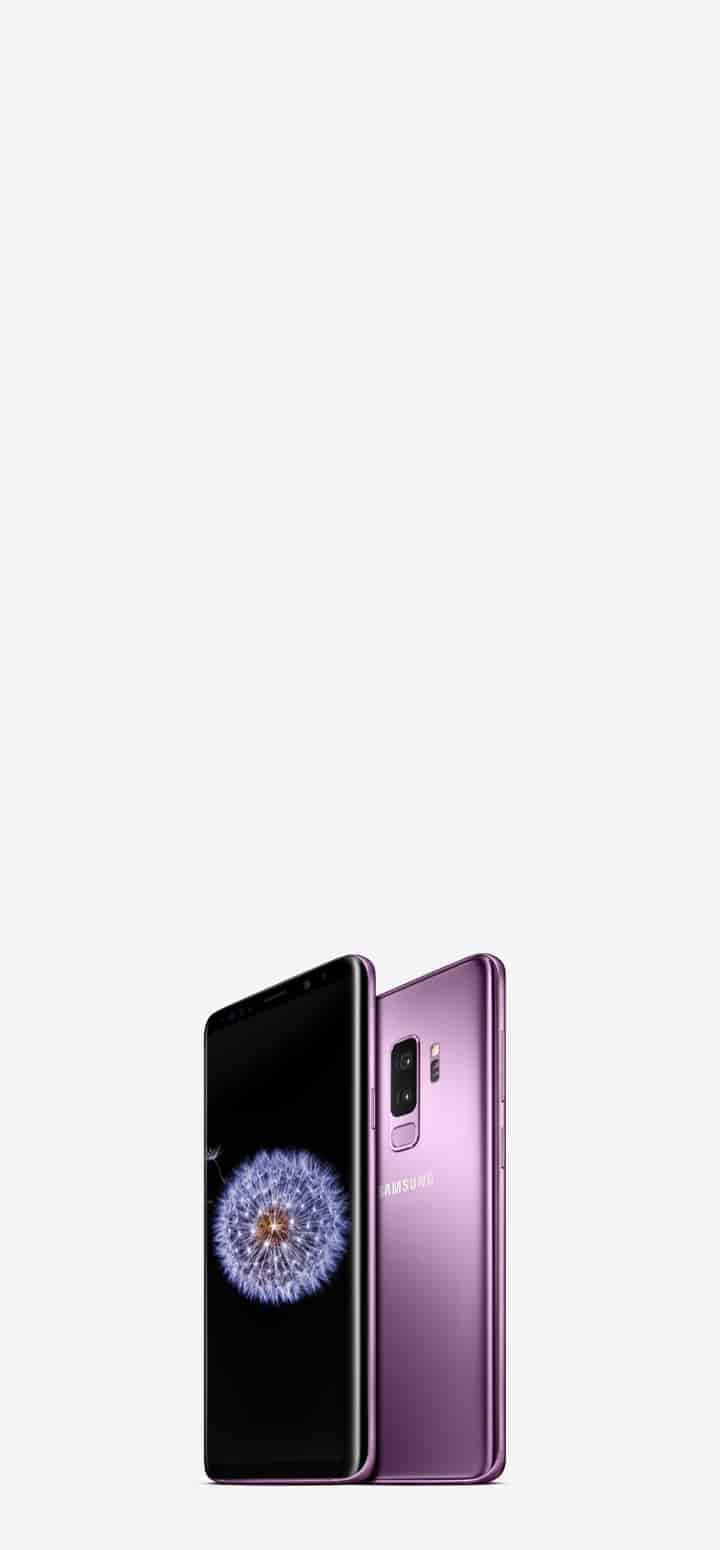 View of two lilac, purple Samsung phones. One facing right and one facing left. The screen features a daisy. View of two lilac, purple Samsung phones. One facing right and one facing left. The screen features a daisy.