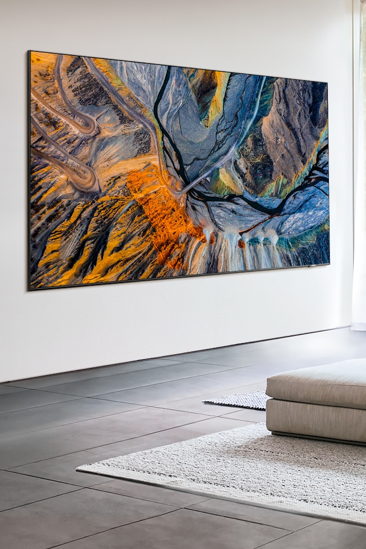 2020 Samsung QLED TV with big screen is displaying a photo which is shown immersive picture quality in the living room using Quantum Processor.