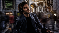 Man listening to Dolby Atmos sound from his Samsung Phone