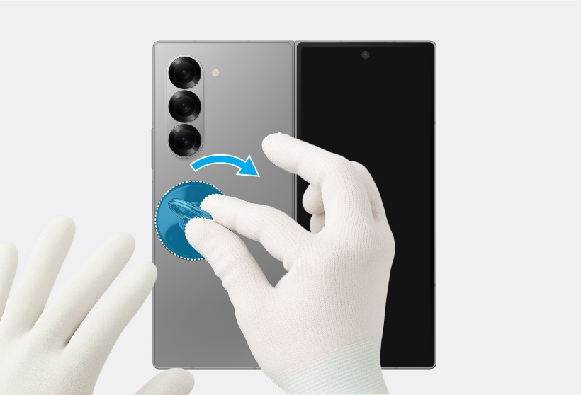 Gloved hands using a suction cup to separate the Galaxy Z Fold6 back glass along the edges.
