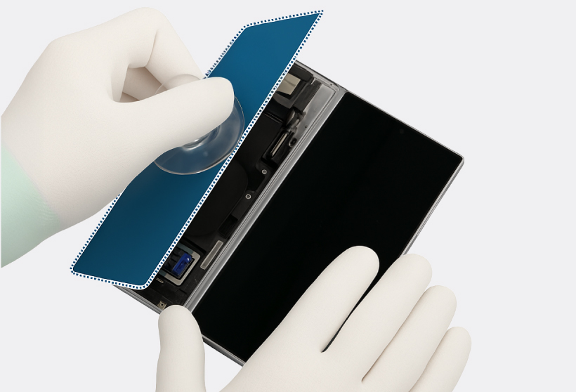 Gloved hands lifting and removing the Galaxy Z Fold6 back glass, showing the exposed internal components.