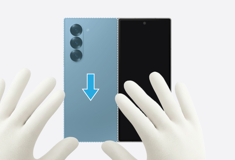 Gloved hands pressing down on the edges of the back cover of the Galaxy Z Fold6.