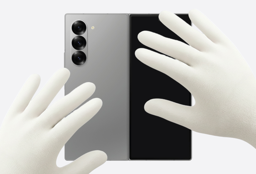 Gloved hands pressing down the deges of the back cover of the Galaxy Z Fold6.