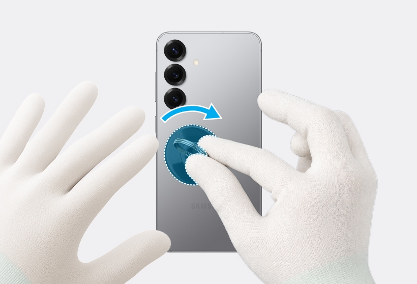 Gloved hands rotating the suction cup on the Galaxy S25 back glass to lift it.