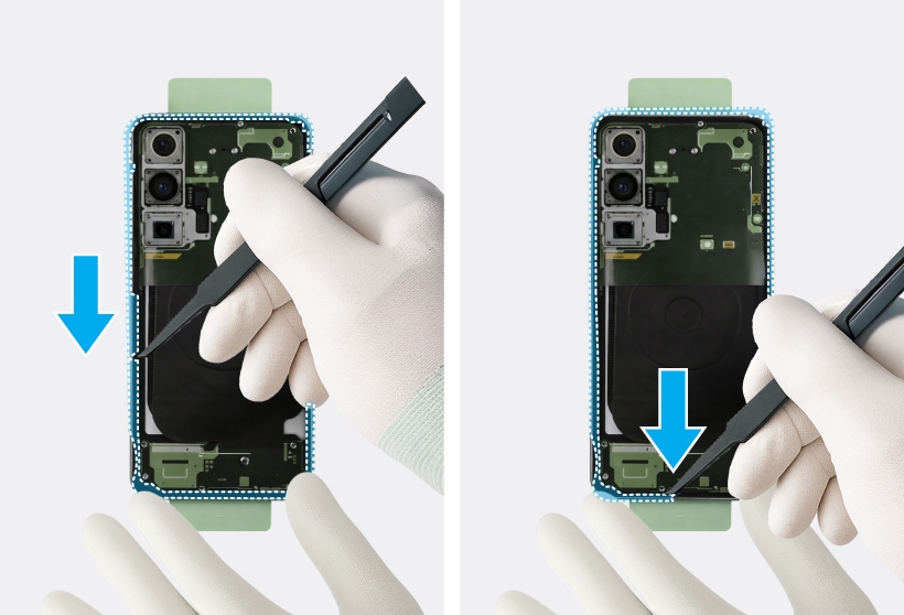Gloved hands removing adhesive film near the camera and battery areas inside the Galaxy S25.