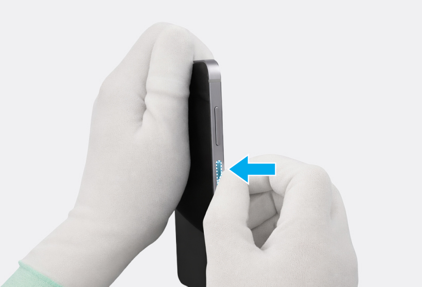 Gloved hand inserting the short side button into the side of the phone frame.