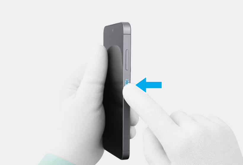 Finger pressing the side button into the side of the phone frame.