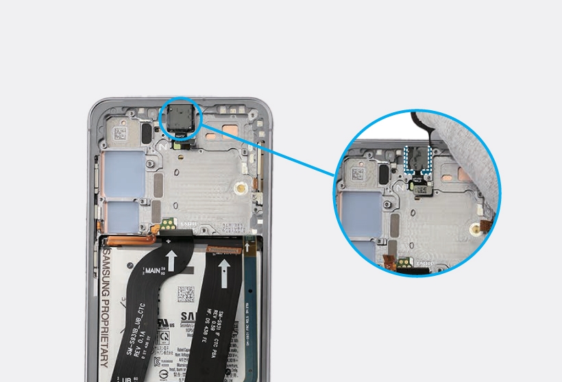 Gloved hands using a SIM ejector pin to separate the adhesive between the front camera and the screen module.