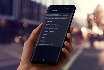 Hand holding phone displaying Bixby Language and Voice Style Hand holding phone displaying Bixby Language and Voice Style