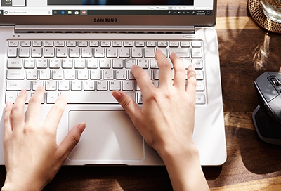 Person typing on a Samsung Notebook keyboard 