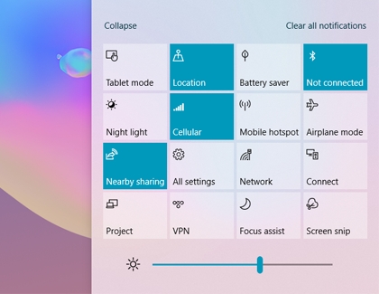 Action Center with quick settings and a brightness slider bar below