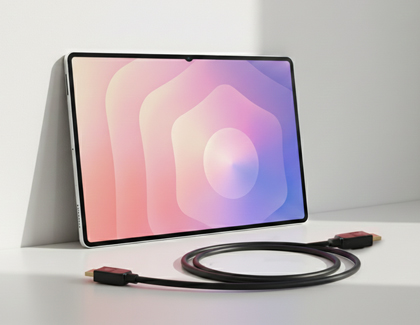 A Galaxy tablet leaning against a wall with a coiled HDMI to USB C cable in the foreground.