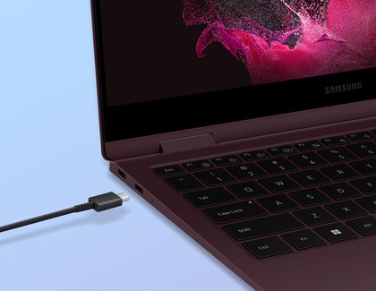 A USB type C cable being inserted into a Samsung laptop