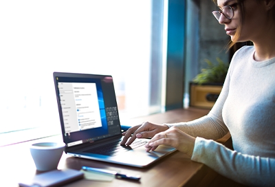 Woman on PC and sitting at desk Woman on PC and sitting at desk