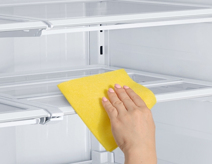 Cleaning refrigerator with a microfiber cloth