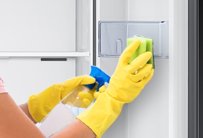 Woman cleaning inside of the kimchi refrigerator