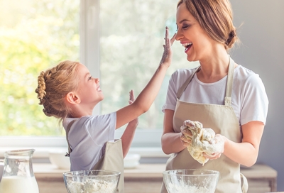 Mother and daughter baking together and having fun