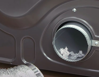 A close-up of an exhaust vent with lint inside on a Samsung dryer