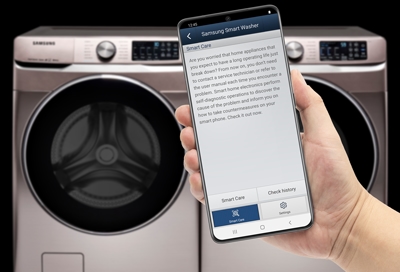 Smart Care on phone next to Samsung washer dryer set