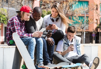 A group of friends hanging out and on their phones A group of friends hanging out and on their phones