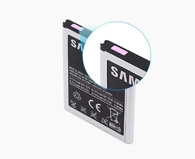 Close-up image of a Samsung battery with a close-up inset showing the Liquid Damage Indicator (LDI) strip at the top, which is highlighted pink indicating exposure to liquid. The battery has regulatory markings and the Samsung logo on its surface