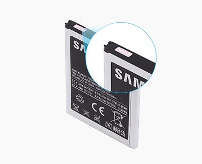 A Samsung battery is displayed with a close-up view on its Liquid Damage Indicator (LDI) at the top corner, showing a pink color which indicates exposure to liquid. The battery bears safety and regulatory information