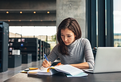 Woman studying in a library Woman studying in a library