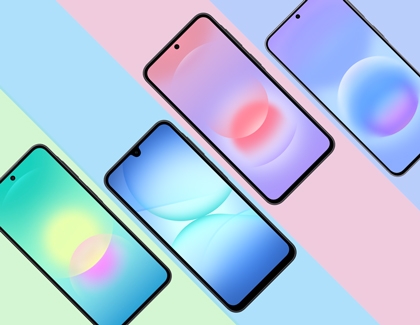 Four Galaxy A series phones arranged diagonally on a striped pastel background with each screen showing a unique colorful wallpaper.