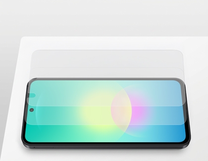 A Galaxy phone lying flat on a white surface with two transparent screen protectors hovering above the display.