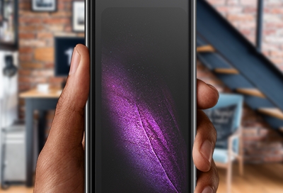 Person holding a Galaxy Fold in a creative office Person holding a Galaxy Fold in a creative office