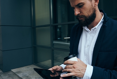 Man in suit using the Galaxy Fold Man in suit using the Galaxy Fold