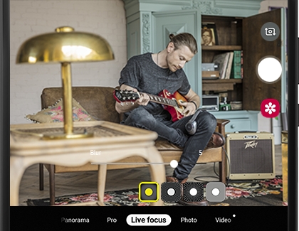 man playing guitar is photographed with live focus man playing guitar is photographed with live focus