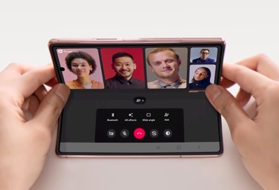 Woman using the Galaxy Fold to video chat friends Woman using the Galaxy Fold to video chat friends