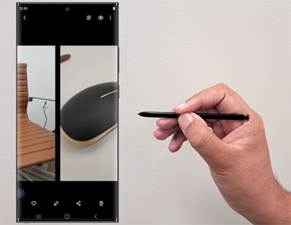 Person pointing S Pen at a Galaxy phone Person pointing S Pen at a Galaxy phone