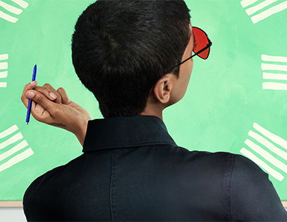 A man holding an S Pen while looking at a board A man holding an S Pen while looking at a board